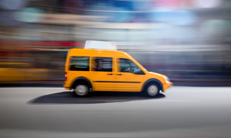 Yellow taxi zooming by.の写真素材