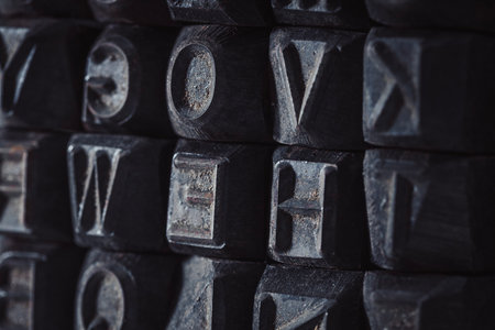 vintage printer blocks stack, antique letters background.
