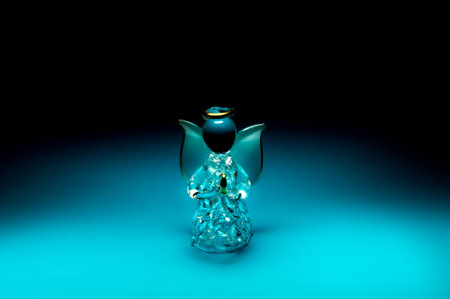 Glass angel on dark blue background