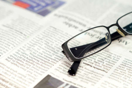 A newspaper and a pair of glassesの写真素材