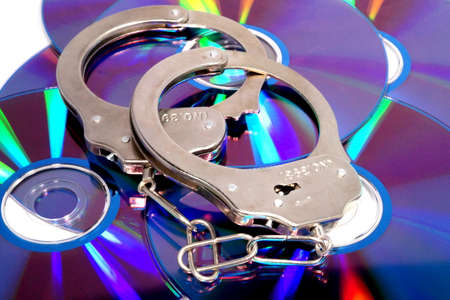 Handcuffs and illegally copied CDsの写真素材
