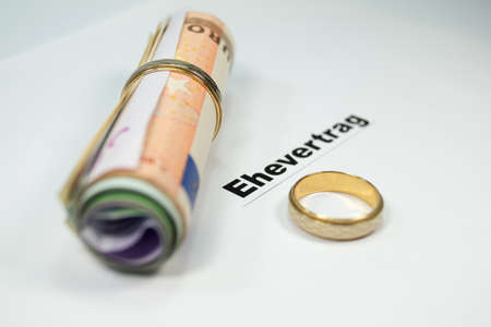 A prenuptial agreement and wedding ringsの写真素材