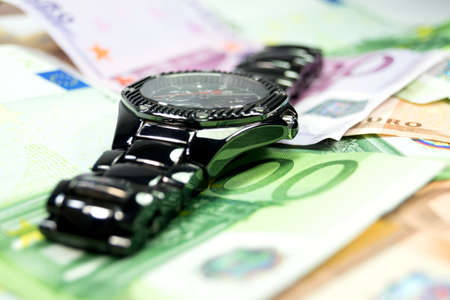 A wristwatch and cashの写真素材