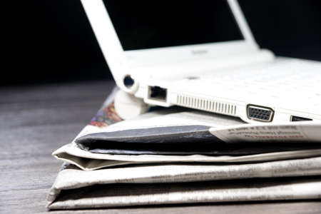 Laptop and newspaperの写真素材