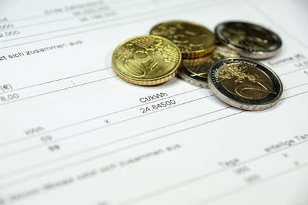 Electricity bill with coinsの写真素材