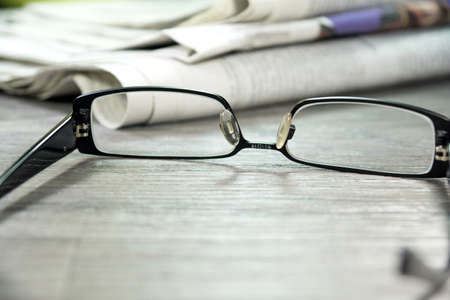 Newspapers and reading glassesの写真素材
