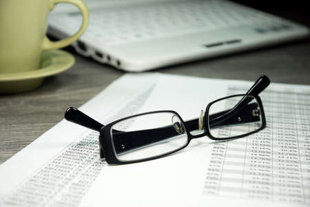 A cup of coffee and a spreadsheetの写真素材