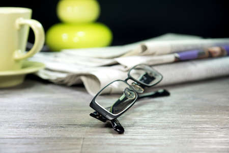 Newspaper, glasses and cup of coffeeの写真素材