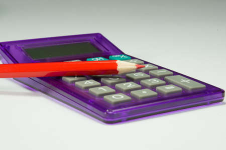 red crayon on calculatorの写真素材