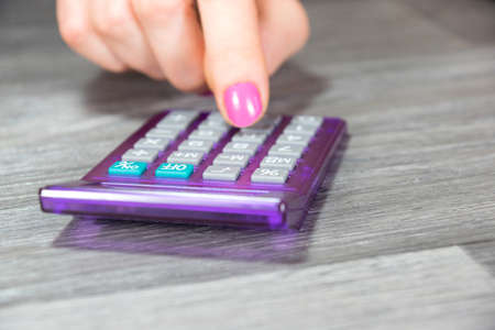 woman's hand with calculator