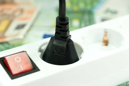Electrical socket and moneyの写真素材