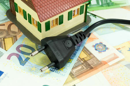 Power line, money and a houseの写真素材