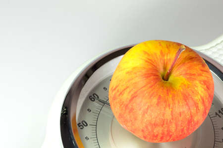 bathroom scales and an appleの写真素材