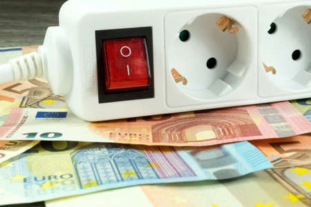Electrical socket and moneyの写真素材
