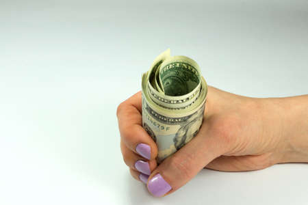 A woman holding dollar bills in handの写真素材