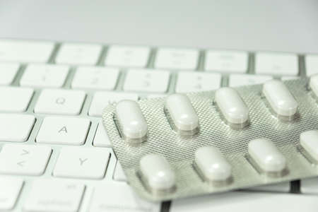 Pills on a keyboardの写真素材