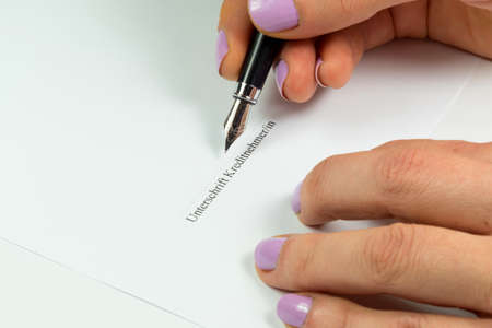 Woman signs a loan agreement
