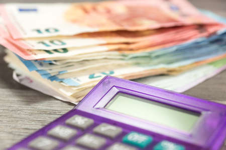 Euro bills and a calculatorの写真素材