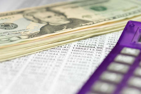 A spreadsheet and accounting and dollar billsの写真素材