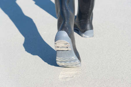 Walk on the beach in rain bootsの写真素材