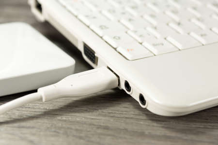 An external hard drive and a computerの写真素材