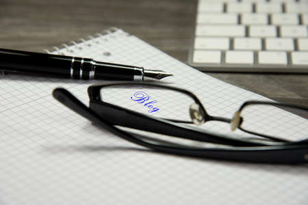 Blogging, keyboard and glassesの写真素材