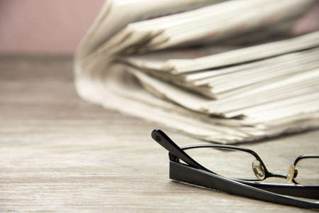 Newspapers and glasses on the table
