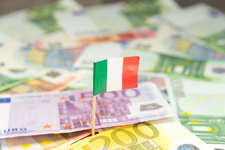 Italian flag and many euro banknotesの写真素材
