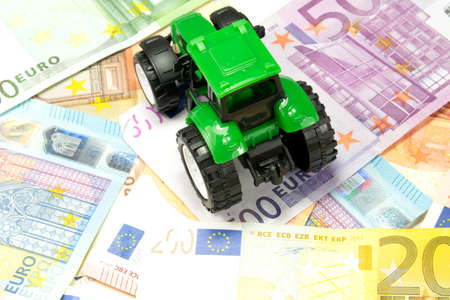 A tractor and moneyの写真素材