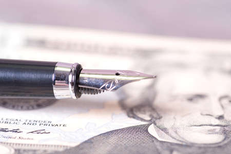 A pen and dollar banknoteの写真素材