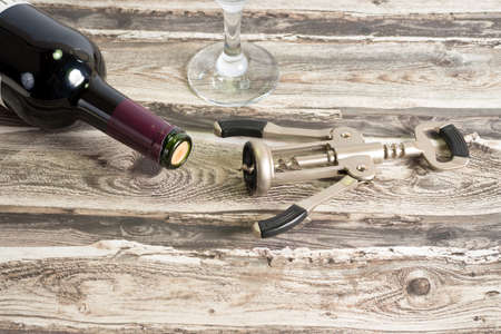 Wine bottle, a glass and a corkscrewの写真素材