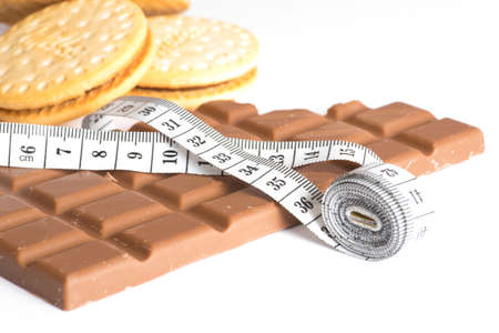 Chocolate, biscuits and a measuring tapeの写真素材