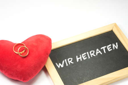 A heart, wedding rings and invitation to a weddingの写真素材