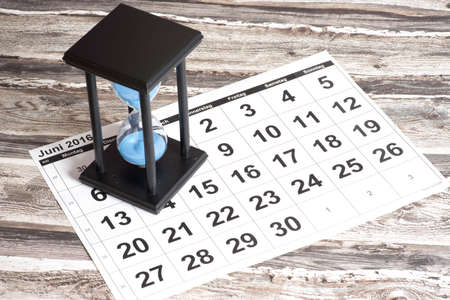 An hourglass and calendar