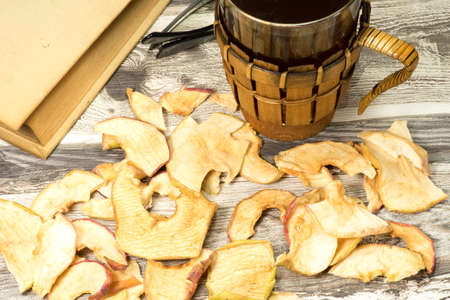 A glass of tea and a bookの写真素材