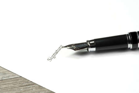 A fountain pen and signature on a contractの写真素材
