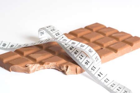 Chocolate and measuring tapeの写真素材