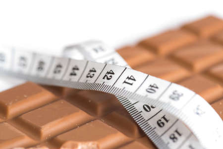 Chocolate and measuring tapeの写真素材
