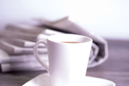 A cup of coffee and newspapersの写真素材