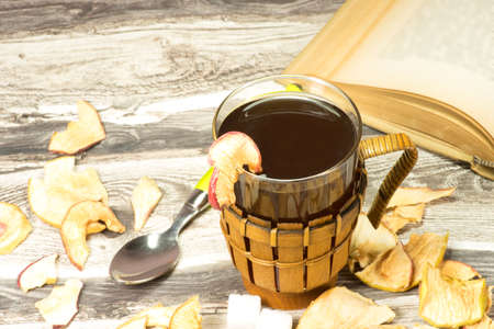 A glass of tea and a bookの写真素材