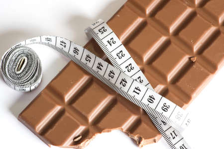 Chocolate and a measuring tapeの写真素材