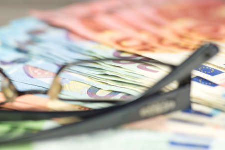 Euro banknotes and glassesの写真素材