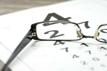 A pair of glasses and a vision testの写真素材