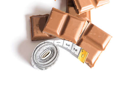 A chocolate and measuring tapeの写真素材