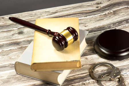 A gavel, handcuffs and statutesの写真素材