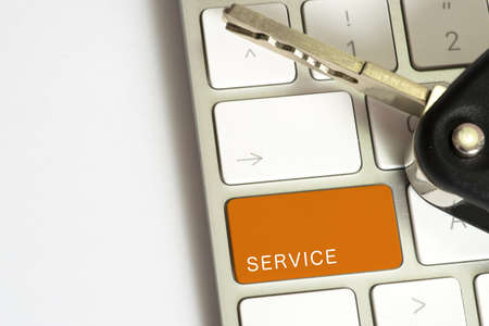 A car key and computer with the key for the workshop searchの写真素材