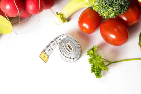Different vegetables and a measuring tapeの写真素材