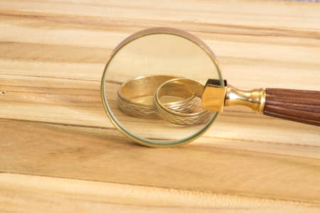 Wedding rings and magnifierの写真素材