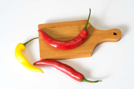 Chilli peppers and chopping boardの写真素材