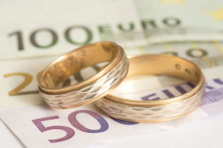 Two wedding rings and euro billsの写真素材